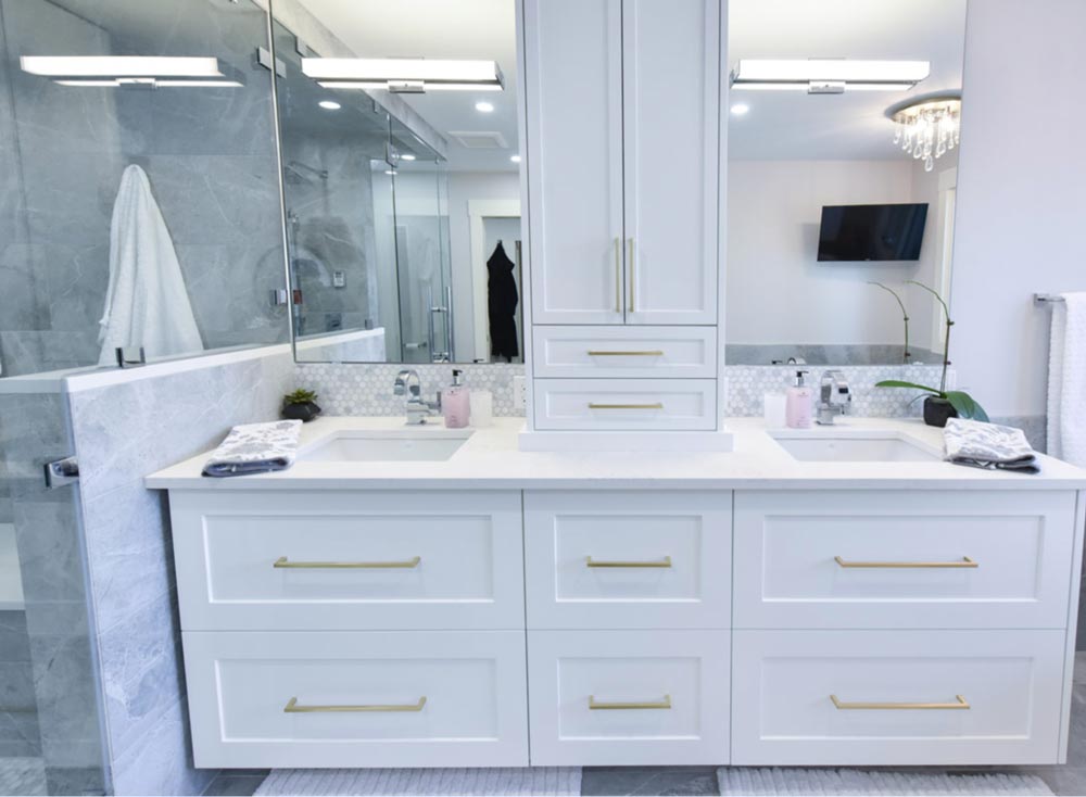 A small bathroom remodel using mirrors to make the space look bigger